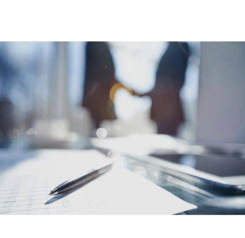 Professionals shaking hands over financial documents